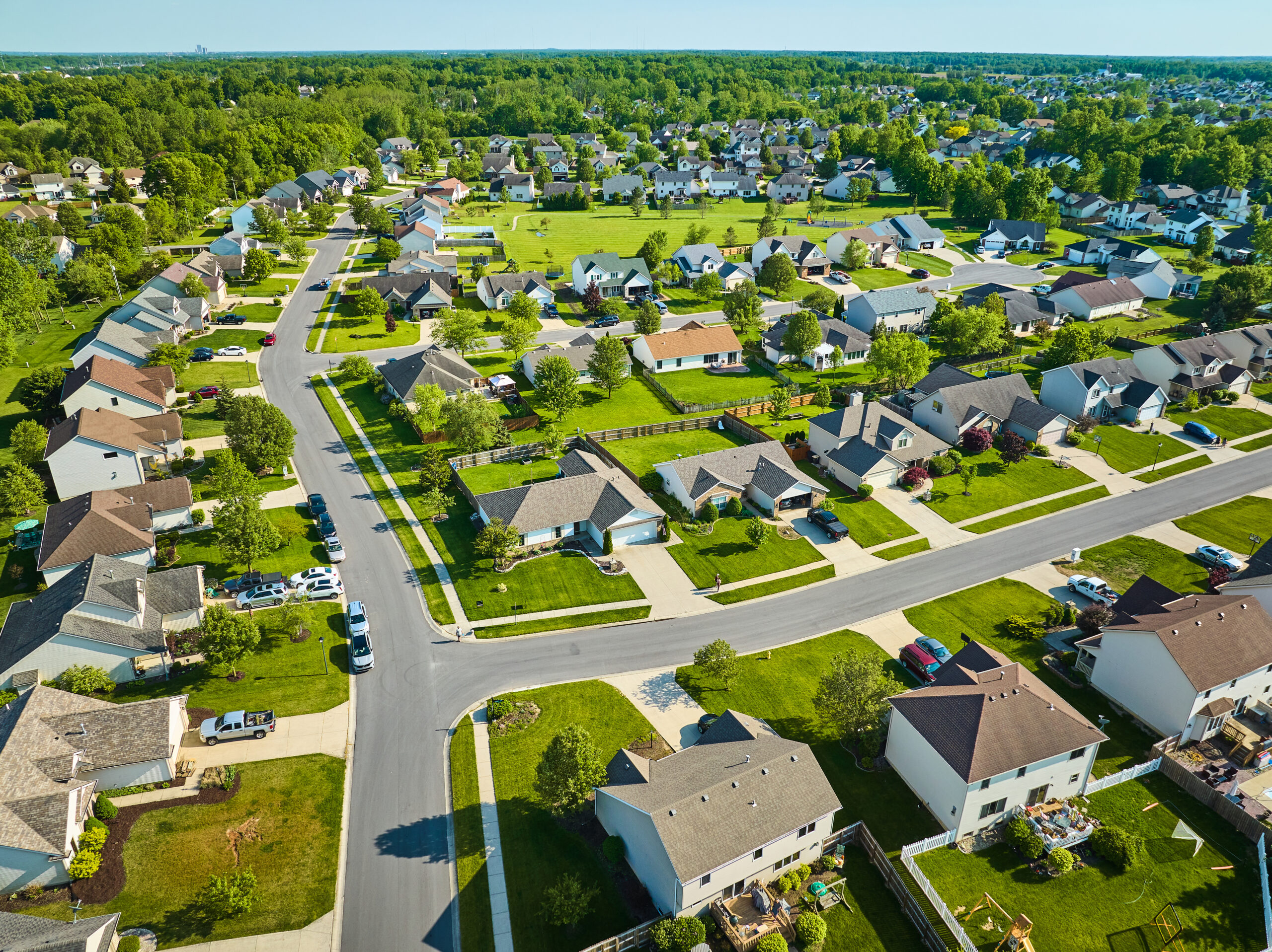 An aerial view of a neighborhood on a warm summer day, with green lawns in Sunnyvale, TX.