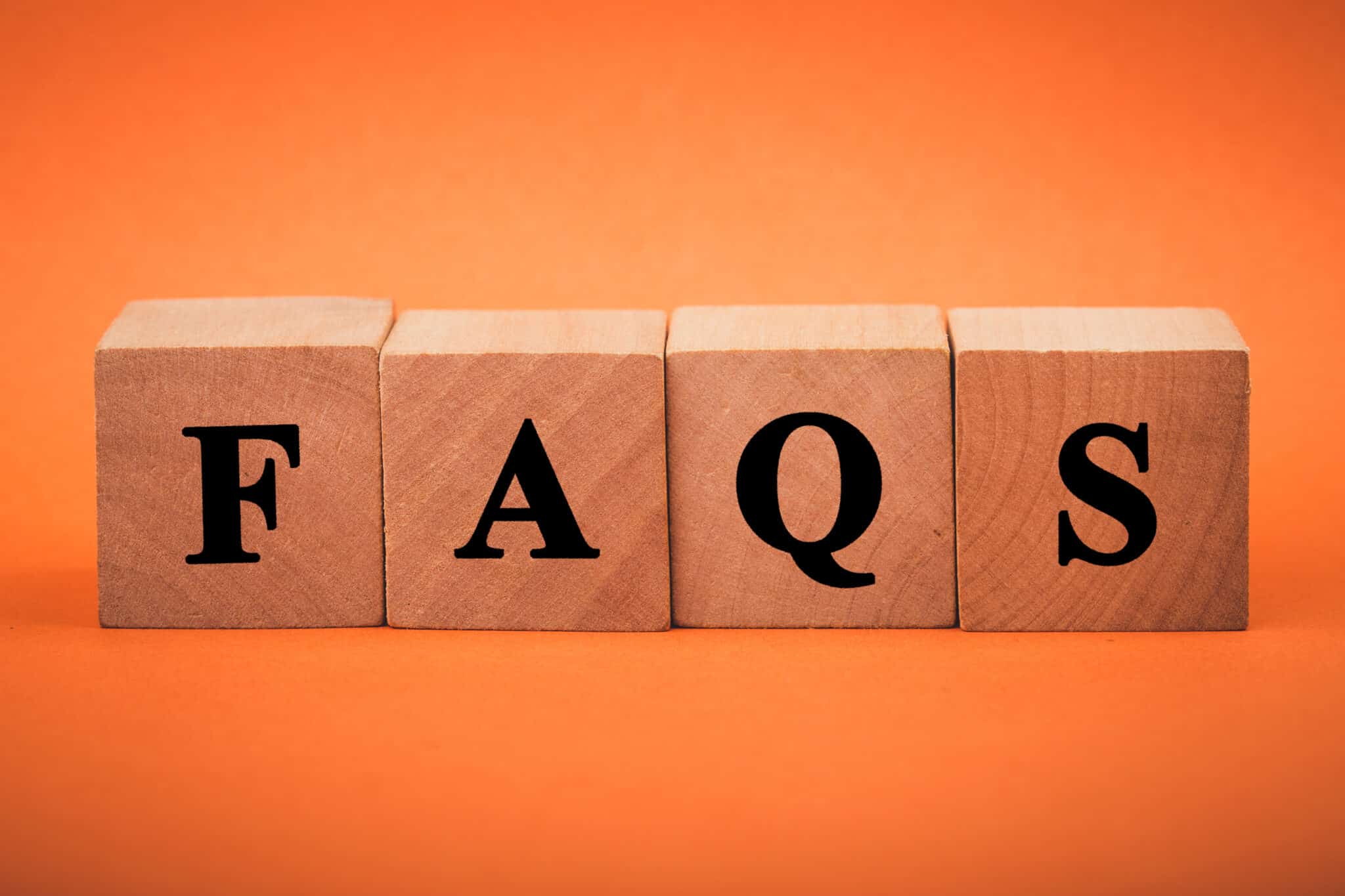 FAQS Text wooden blocks isolated on color background.